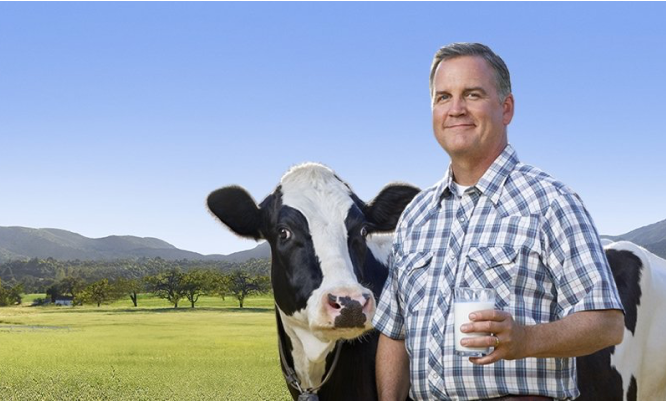 Farmer Dave with a cow and a glass of Lactaid Milk