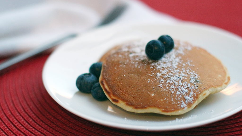 Blueberry-speckled pancakes with powdered sugar