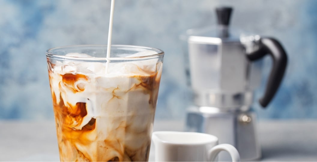 Lactaid Milk being poured into an iced coffee