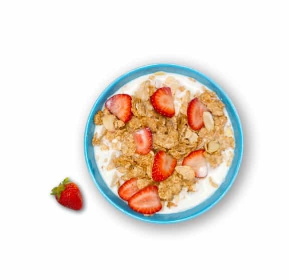 Bowl of cereal with milk and fresh strawberries