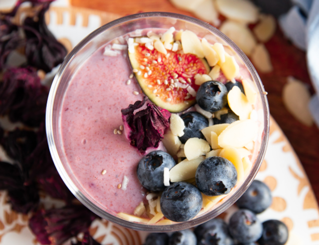 Hibiscus Chia Seed Pudding topped with nuts and fruit