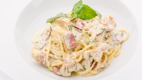 Angel hair pasta with prosciutto in basil cream sauce