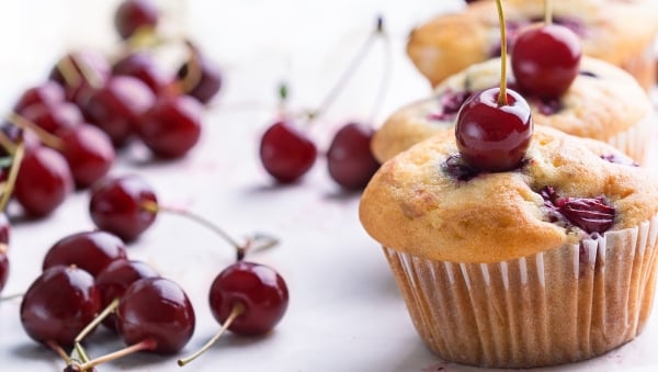 Baked cherry muffins with a cherry on top 