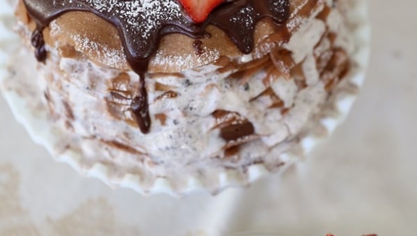 Chocolate crepe layer cake with powdered sugar