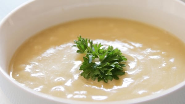 Creamy chicken soup topped with cilantro