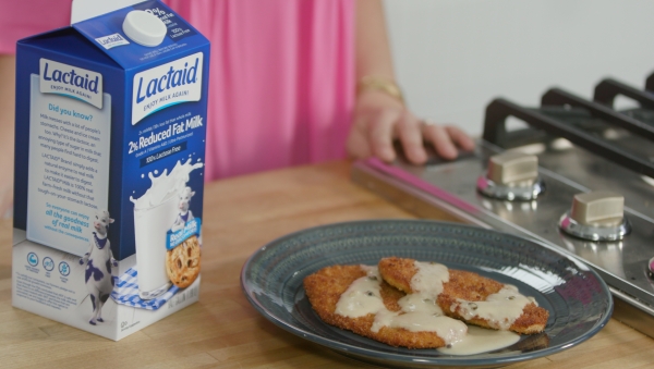 Lactaid 2% Reduced Fat milk next to plate of creamy breaded chicken