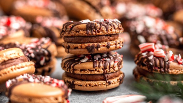Chocolate macaroons with chocolate drizzle and peppermint crumbles
