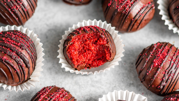 Red velvet cake truffles covered in chocolate and red sugar